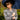 Medium shot of woman wearing 1940s navy blue check suit jacket holding umbrella