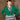 Model wearing 1950s style gemstone green cardigan over a patterned shirt dress