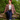 Model wearing red shadow plaid check Downtime jacket sitting on a log outdoors