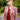 Blonde woman wearing wine red cable knit sweater vest layered under claret check suit jacket
