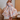 Blonde woman holding out skirt of 1950s cream beach print shirtwaist dress with red heels