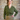 Model wearing 1950s style allotment green cardigan buttoned over a green floral dress