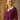 Model wearing 1950s style berry crush cardigan buttoned over a white collared blouse