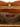 Open interior view of butterscotch faux leather purse showing matching brown lining, zipped pocket, and Socialite brand label