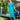 Woman in 1940s teal shirtwaist dress with cream piping holding embroidered straw bag