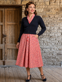 Woman in navy Daydream cardigan and nautical Riviera Yacht Red dress