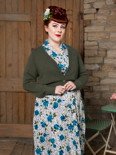 Woman wearing Allotment Green Daydream cardigan over Dreamboat Briar Blue dress