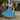 Woman in 1950s teal polka dot Bardot swing dress with petticoat, white hat, and lace gloves