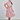 Woman posing in colorful multi stripe 1950s shirtwaist dress with woven belt and red heels