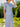 Medium shot of woman wearing blue and cream gingham short sleeve jacket and skirt suit