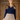 Model wearing 1950s style Midcentury Vintage Daydream Cardigan in dark navy blue buttoned over a plaid dress