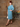 Side profile of redhead woman wearing retro crystal blue midi dress and matching bolero jacket